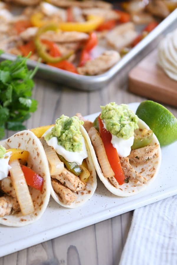 Chicken fajitas with colorful peppers, guacamole and sour cream from Mel’s Kitchen Cafe